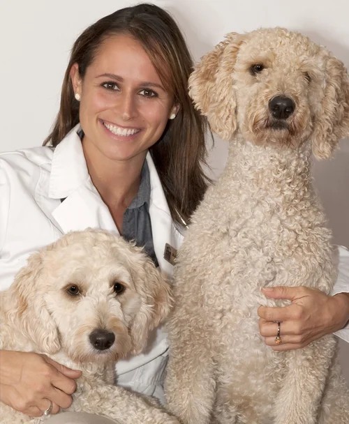 Dr. Brent W. Crutchfield, DVM, smiling with her two dogs.